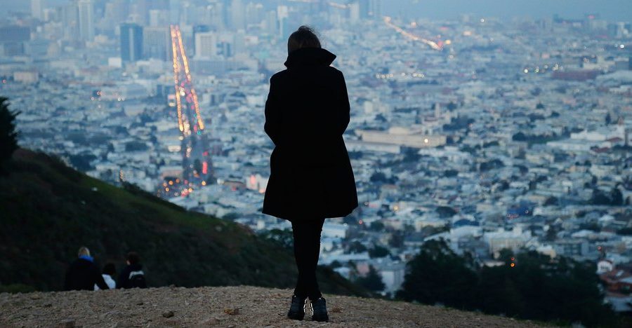 A Surrogate Mom Wearing a Black Coat and Standing on the Mountain - Joy of Life Surrogacy